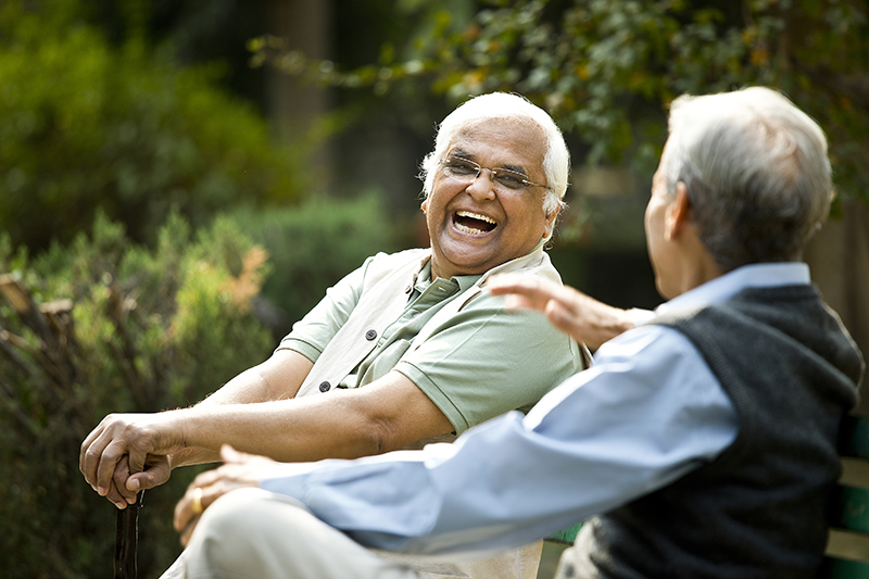 Two senior men discussing on park bench